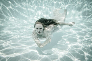 a woman in a dress underwater wedding